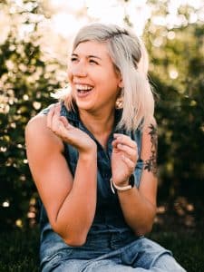 Woman in black tank top smiling. Received chronic fatigue syndrome treatment