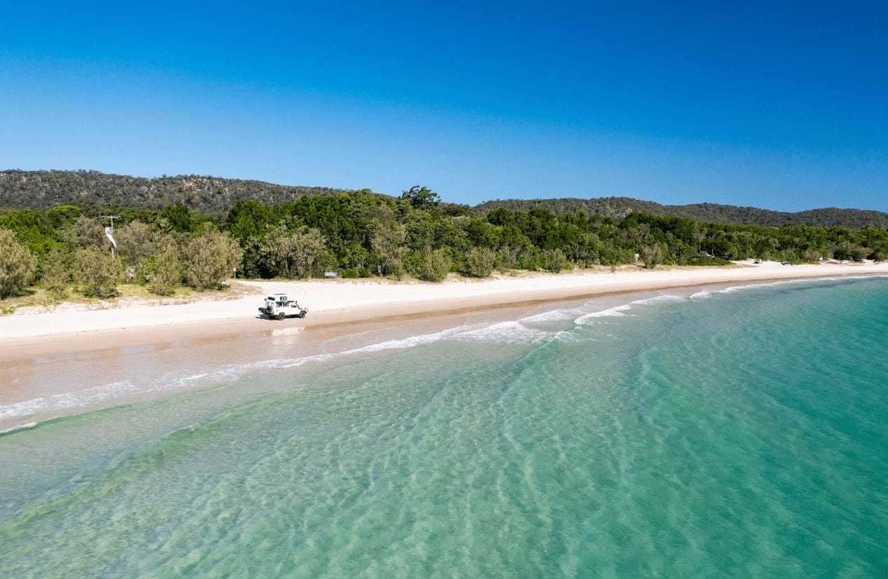 Vechicle driving on the beach. Moreton Bay Region